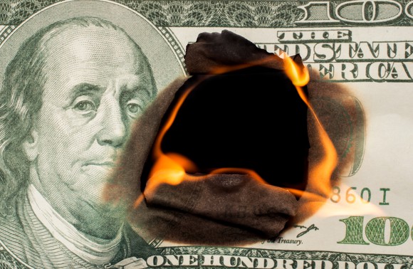 Hundred dollar bill on fire.