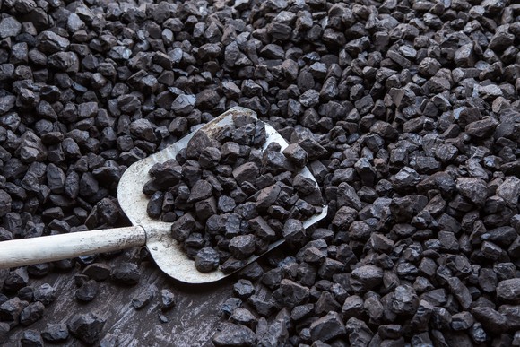 Shovel digging in a pile of coal