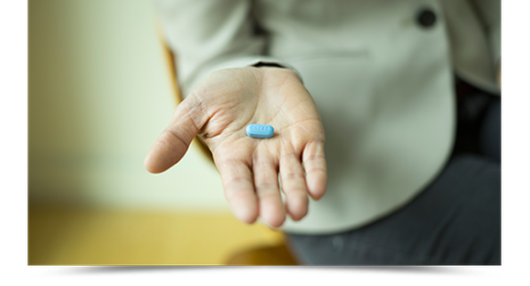 Outstretched hand holding pill