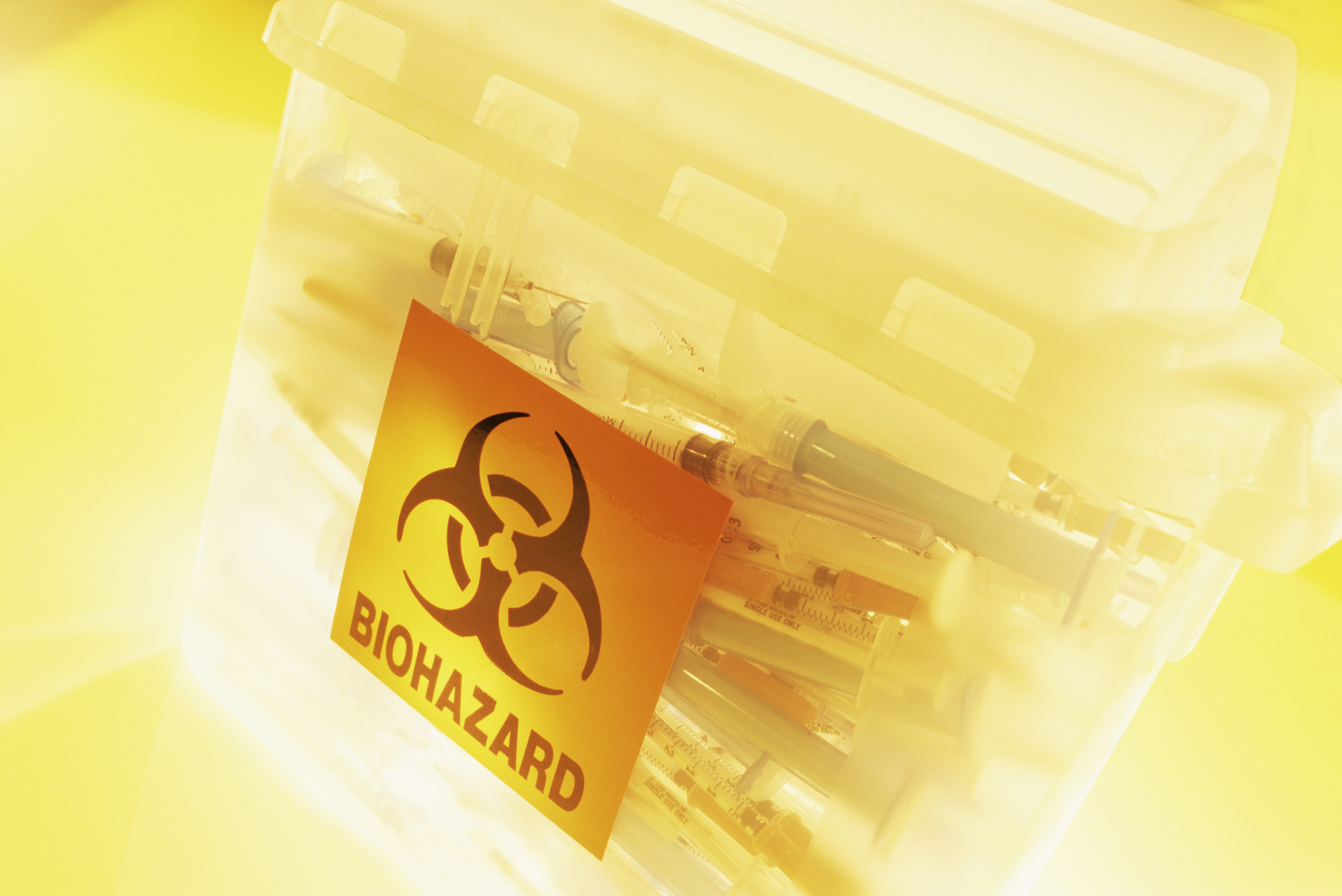 Syringes in a bin for biohazard waste.