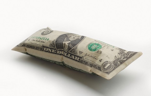 A dollar bill, being inflated like a balloon