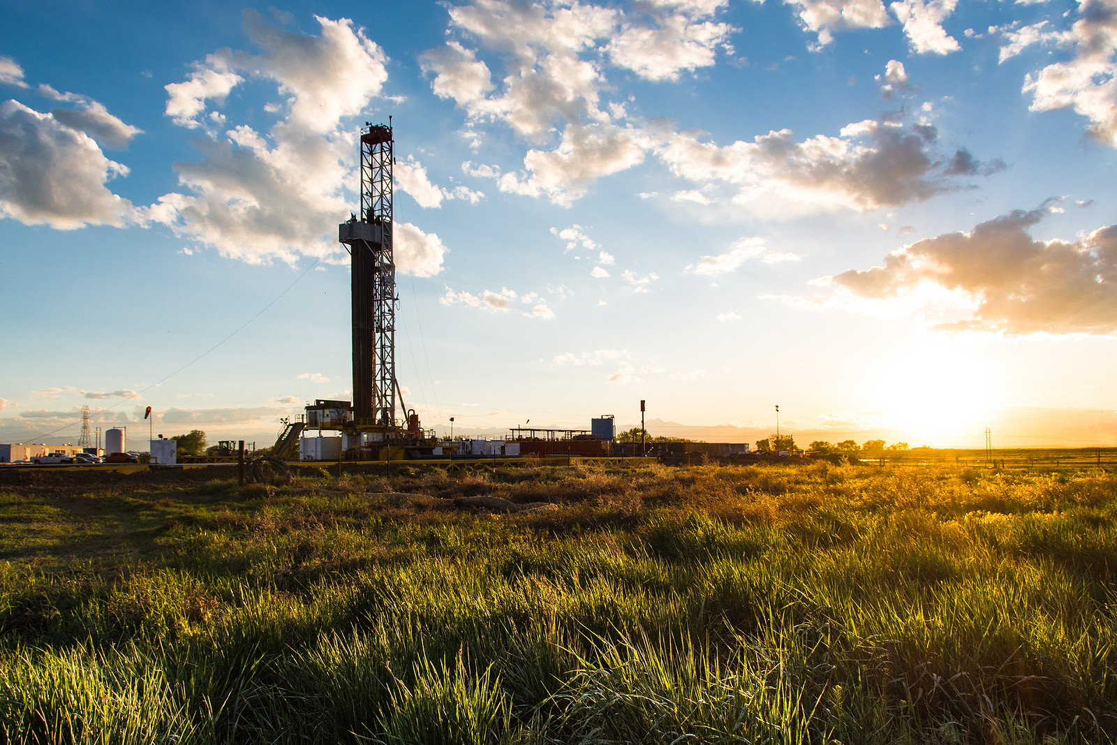 Drilling rig in a field at sunrise.