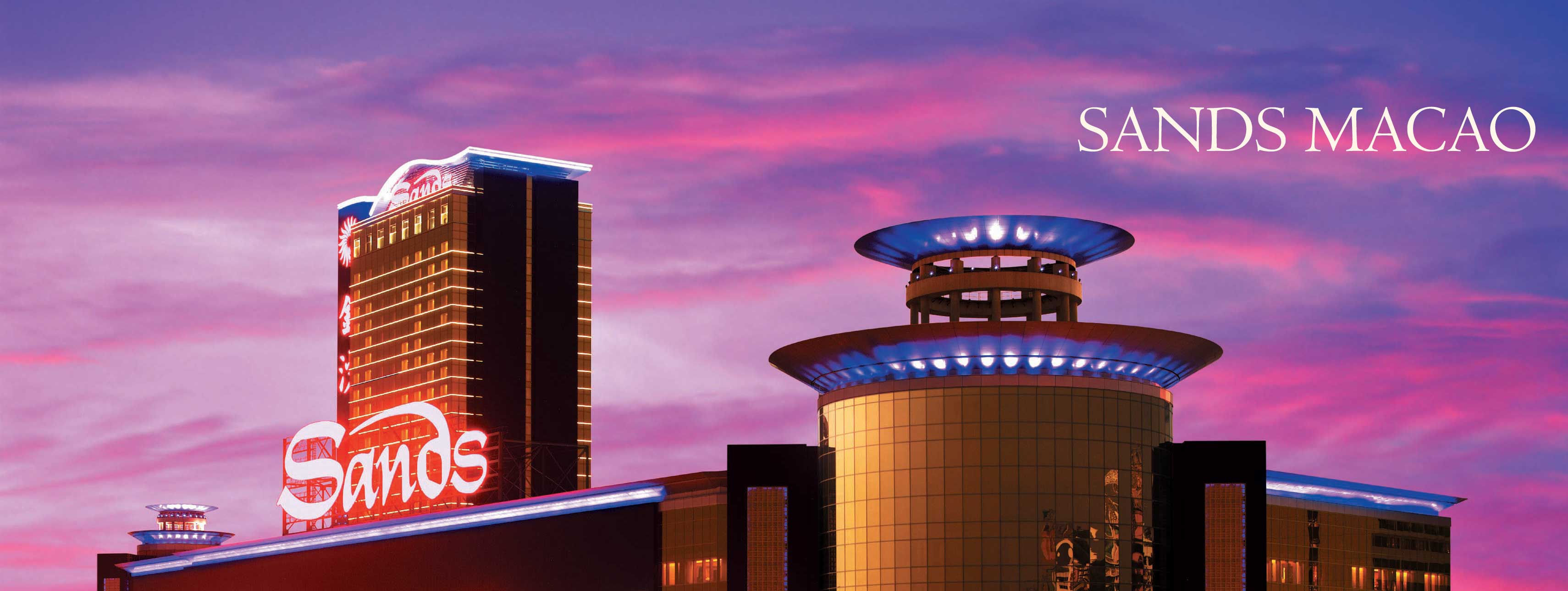 The Sands Macao casino in Macau, China in front of a pink and blue sky.