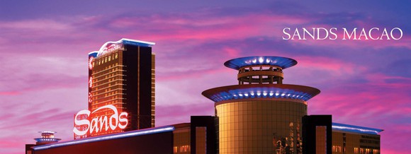 The Sands Macao casino in Macau, China in front of a pink and blue sky.