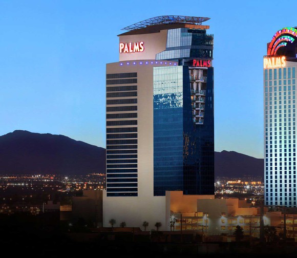 The Palms resort main hotel tower against a dusk sky.