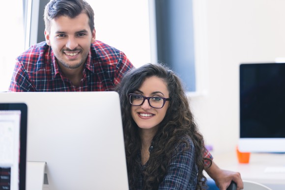 Younger couple working at a computer