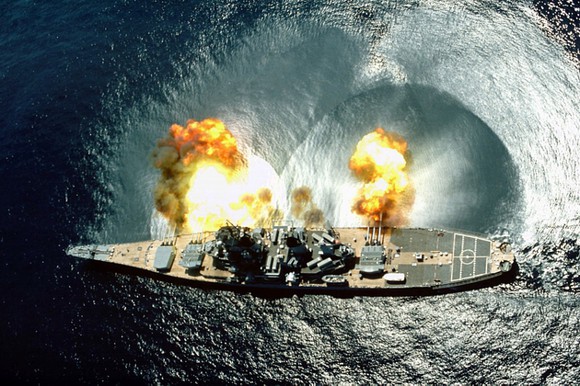 Battleship USS Iowa firing cannon.