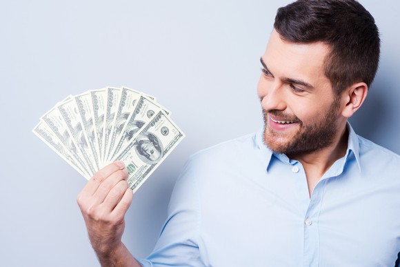 Man holding hundred dollar bills