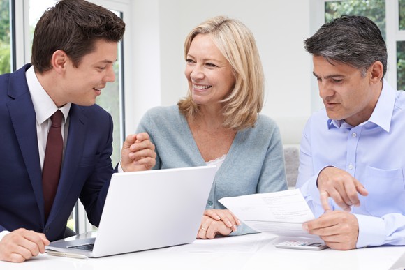 Couple in their 50s meeting with an investment advisor.