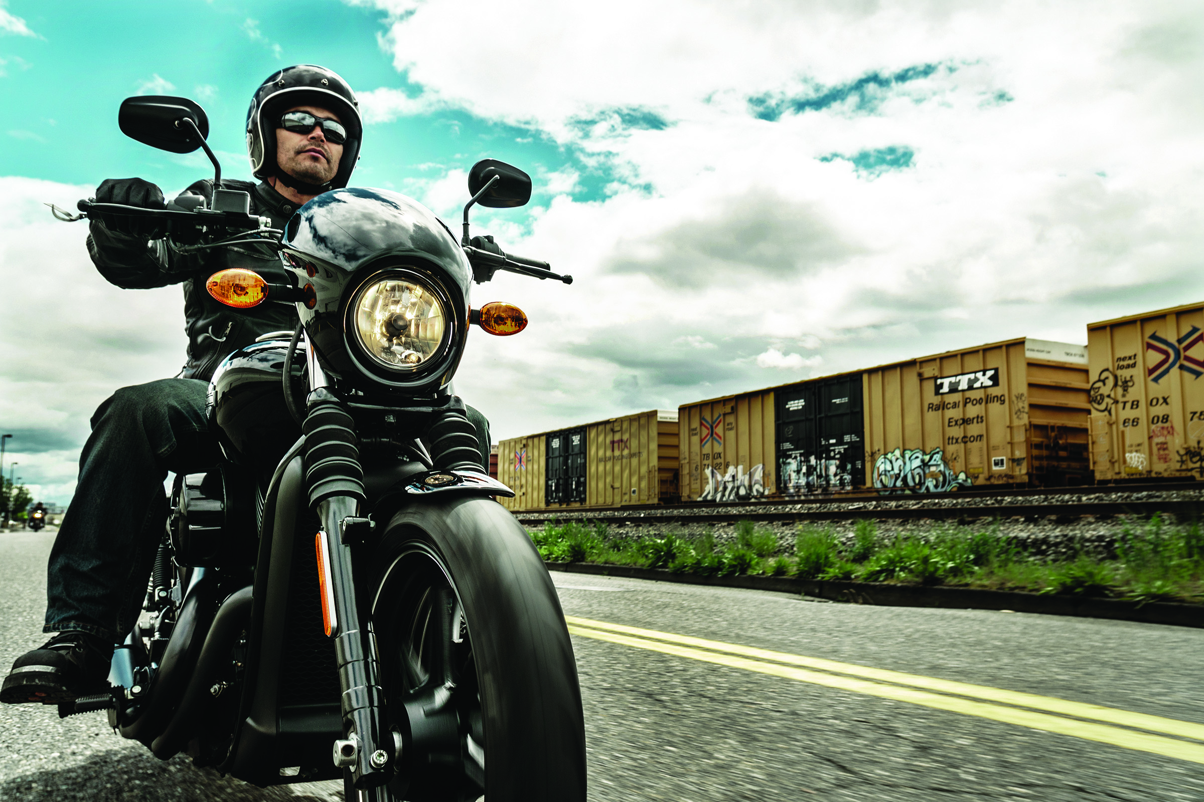 Man riding a Harley-Davidson motorcycle on street