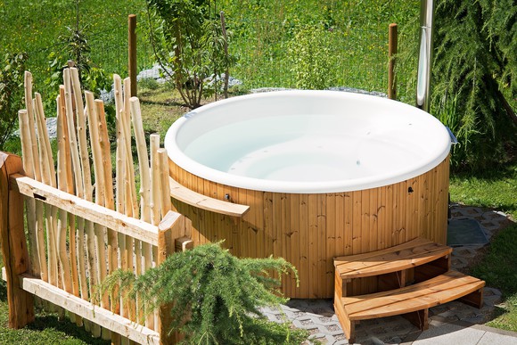 A hot tub is outside.