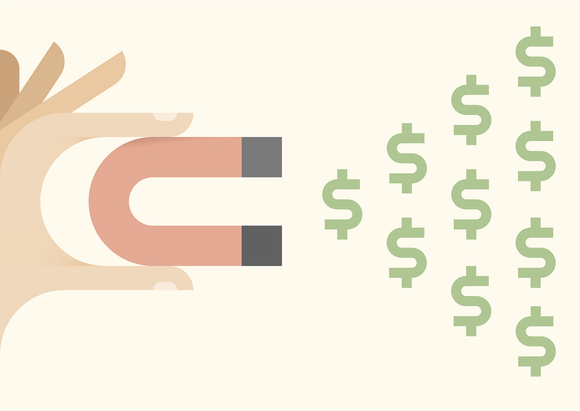 Hand holding a magnet attracting dollar bill signs.