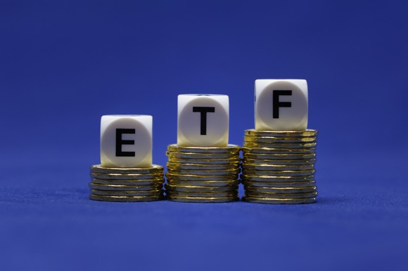 Letter blocks spelling "ETF" on a rising pile of coins