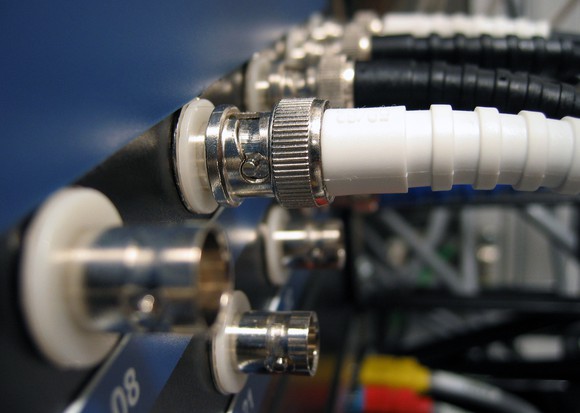Coaxial cables plugged into networking equipment.