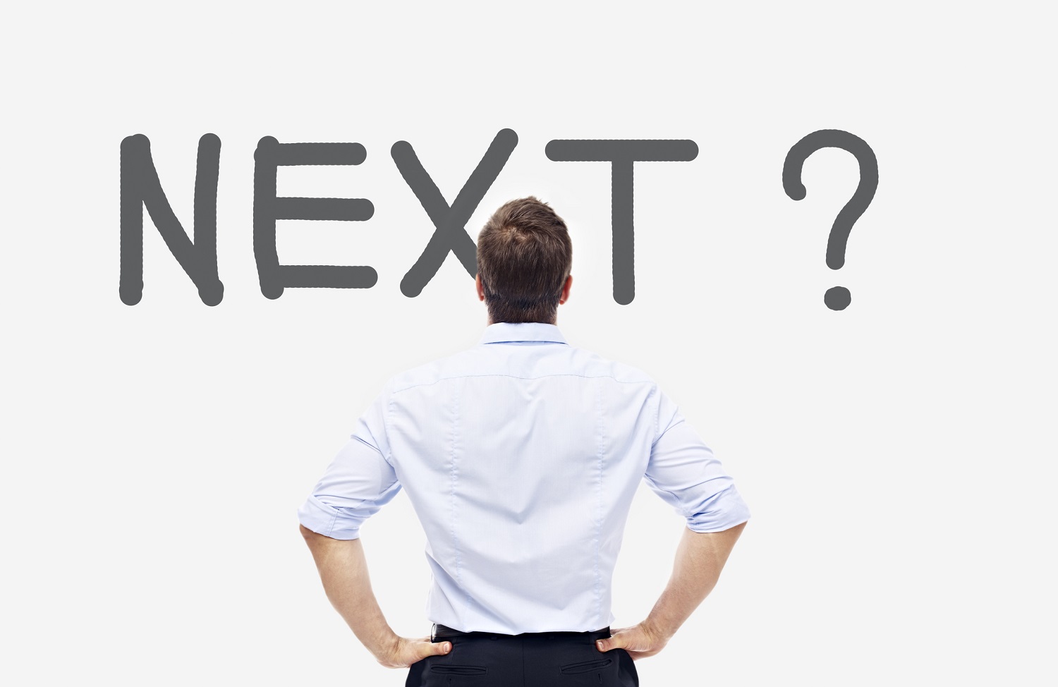 Man standing in front of a sign which reads "next."