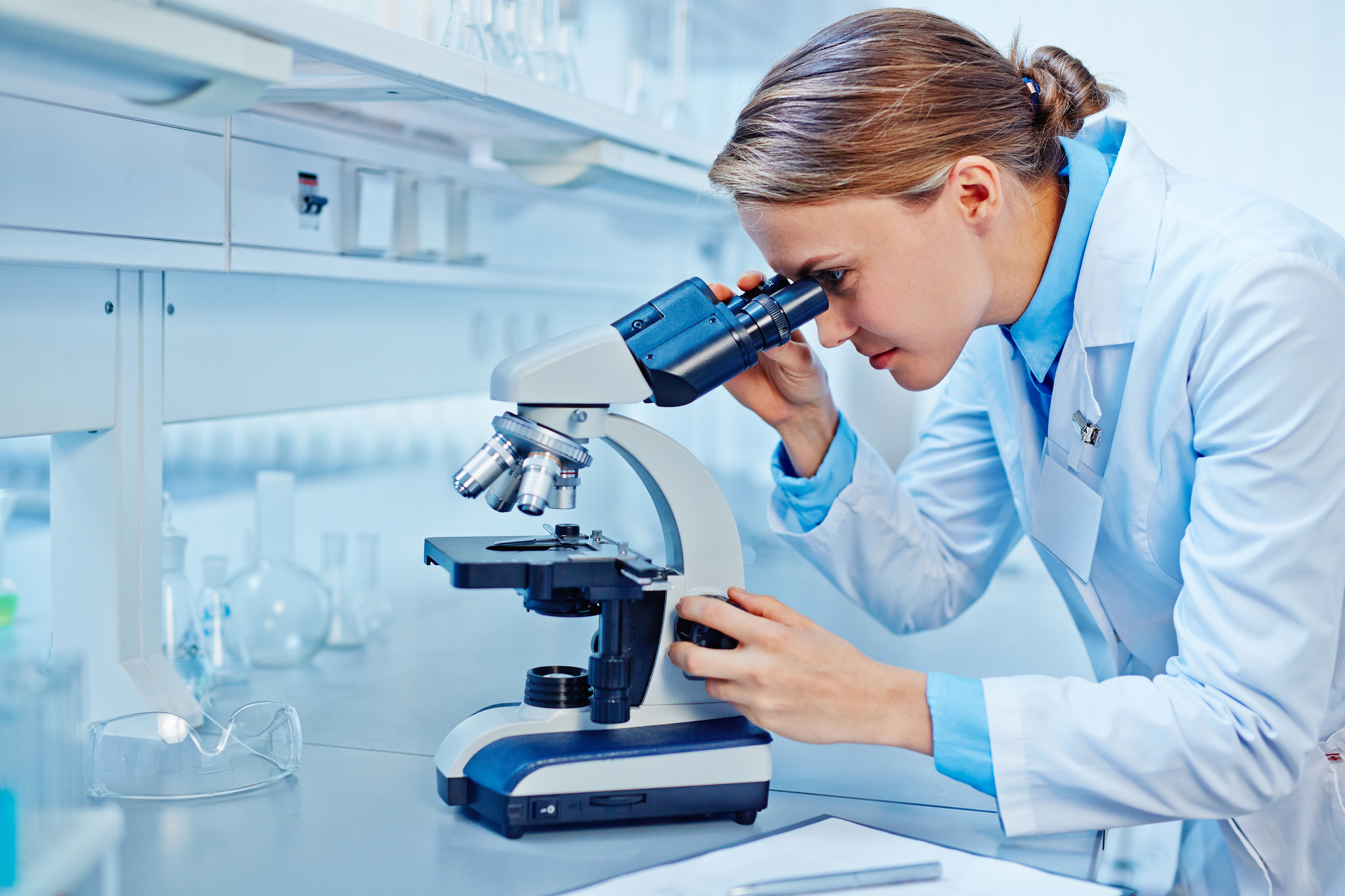 Scientist looking at microscope
