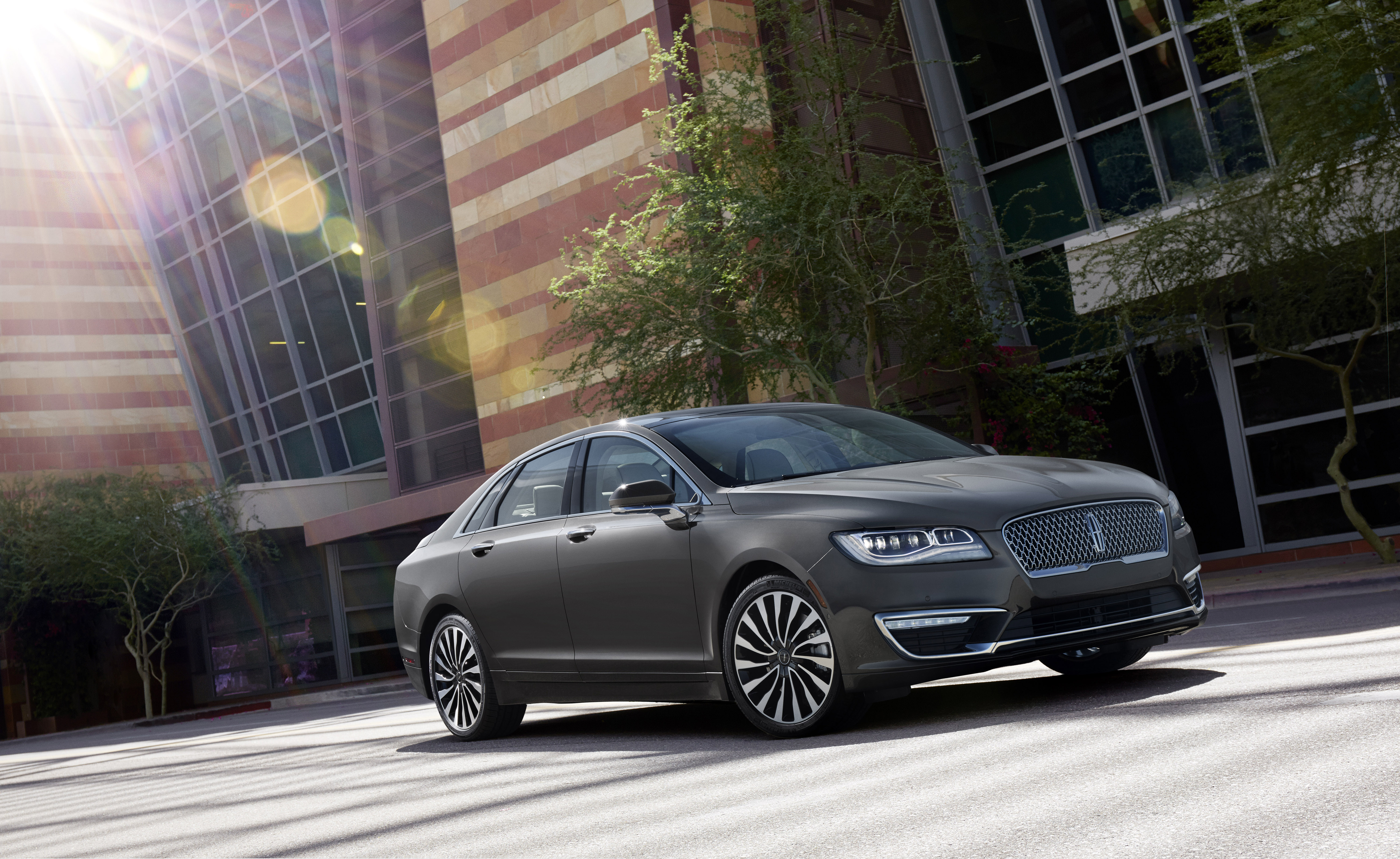 A 2017 Lincoln MKZ parked in front of an office building.