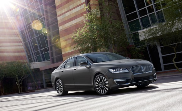 A 2017 Lincoln MKZ parked in front of an office building.
