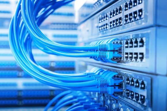 Data cables plugged into servers in a data center.