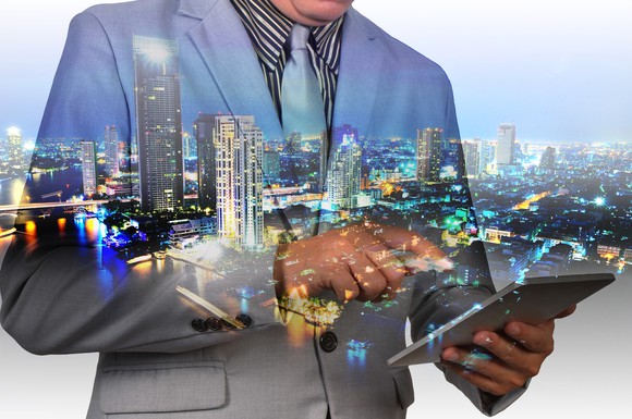 Man looking at real estate information on a tablet.