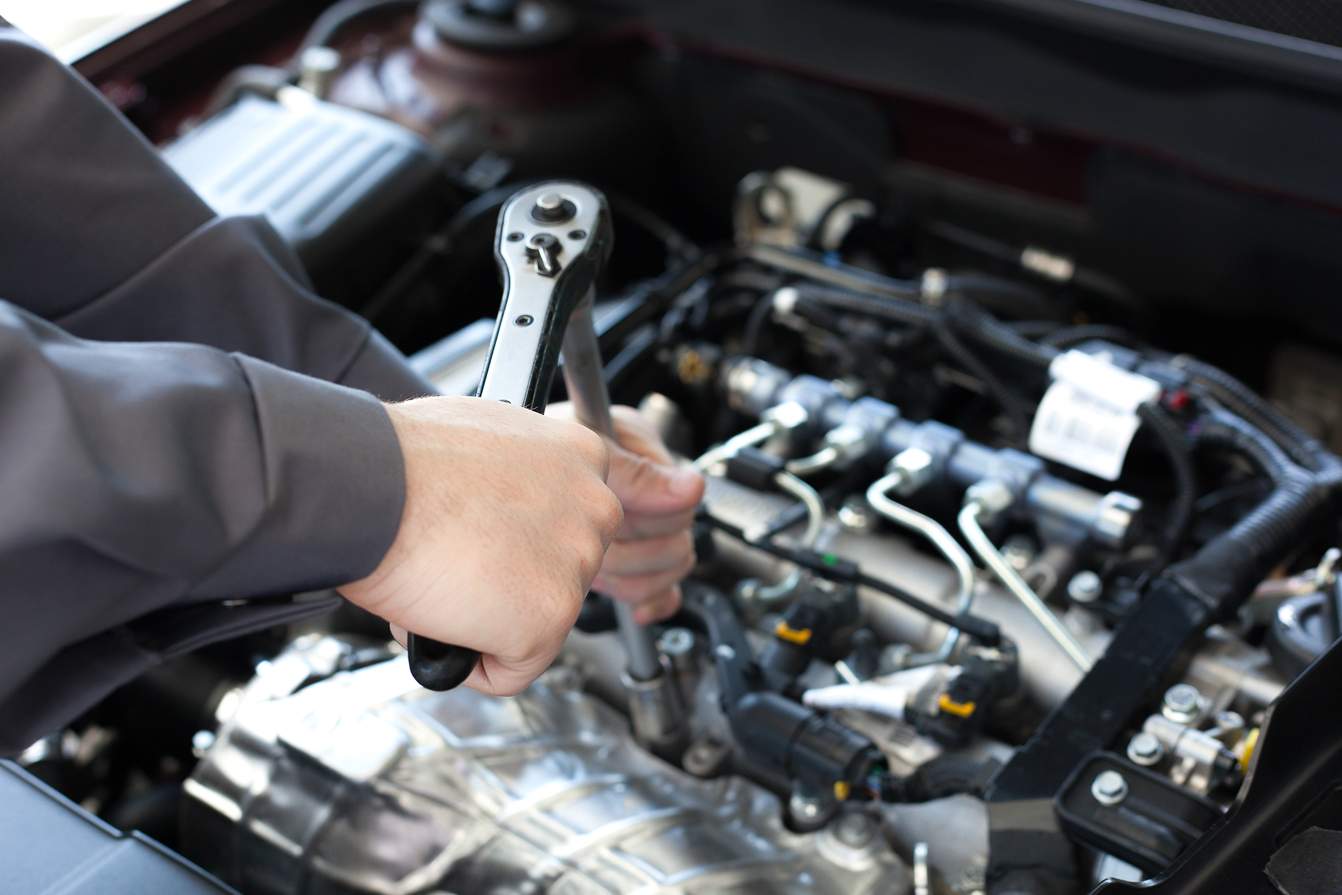 Man working on car engine