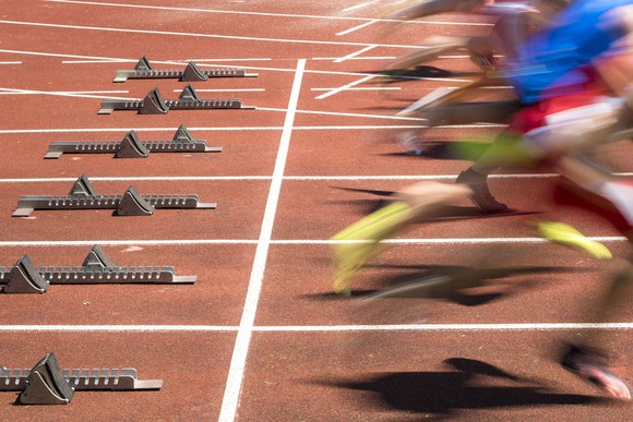 Picture of several runners leaving the starting blocks at a track race.