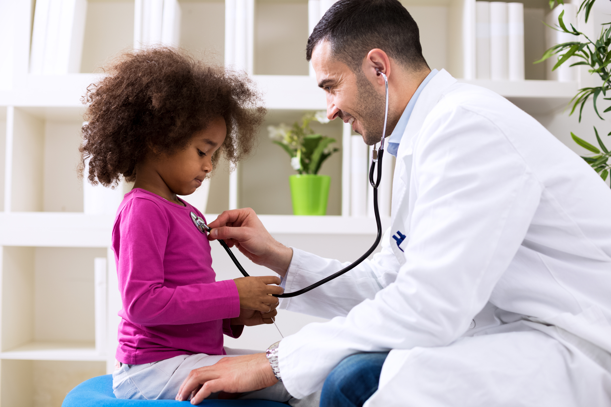 Doctor checking a child's heartbeat.