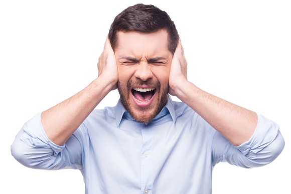 Man with hands over ears