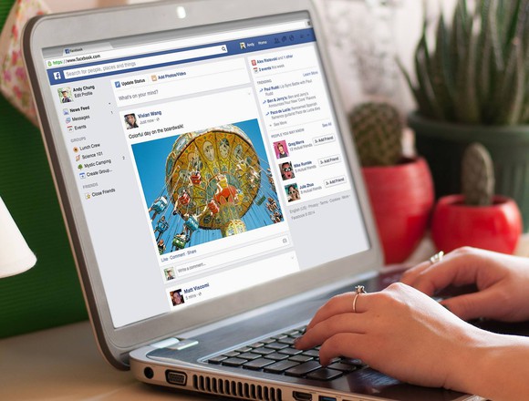 A Facebook feed on a laptop.