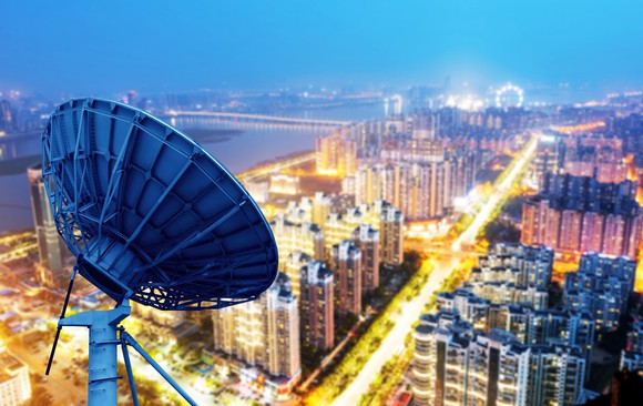 A satellite dish overlooking a city