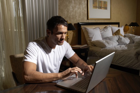 Man on laptop computer.