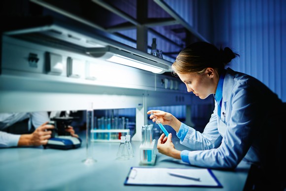 Lab researcher examining test tubes