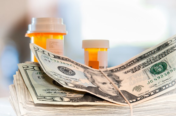 Pill bottles and stack of money