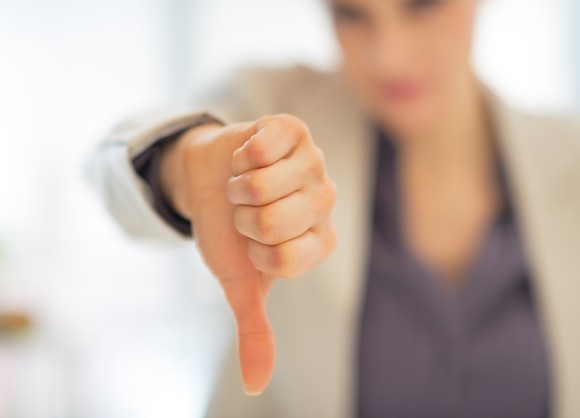 A woman giving a thumbs down.