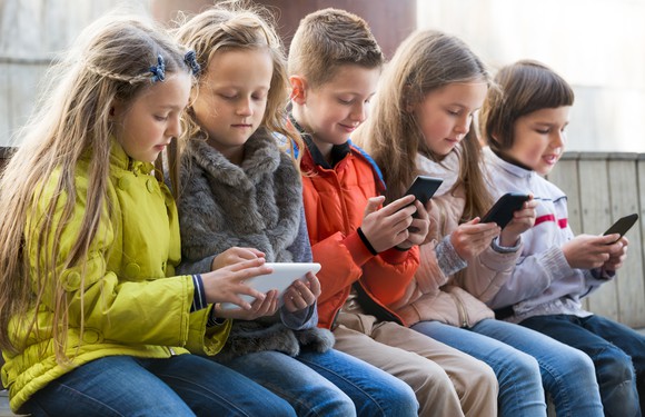 Group of kids all using mobile devices