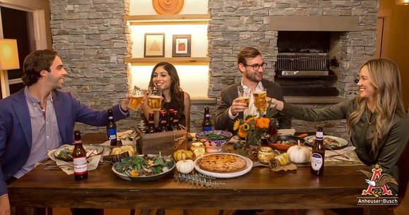 A group of friends together drinking Anheuser-Busch brand beers
