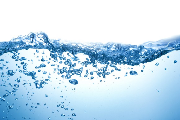 Water with air bubbles below the surface on a white background.