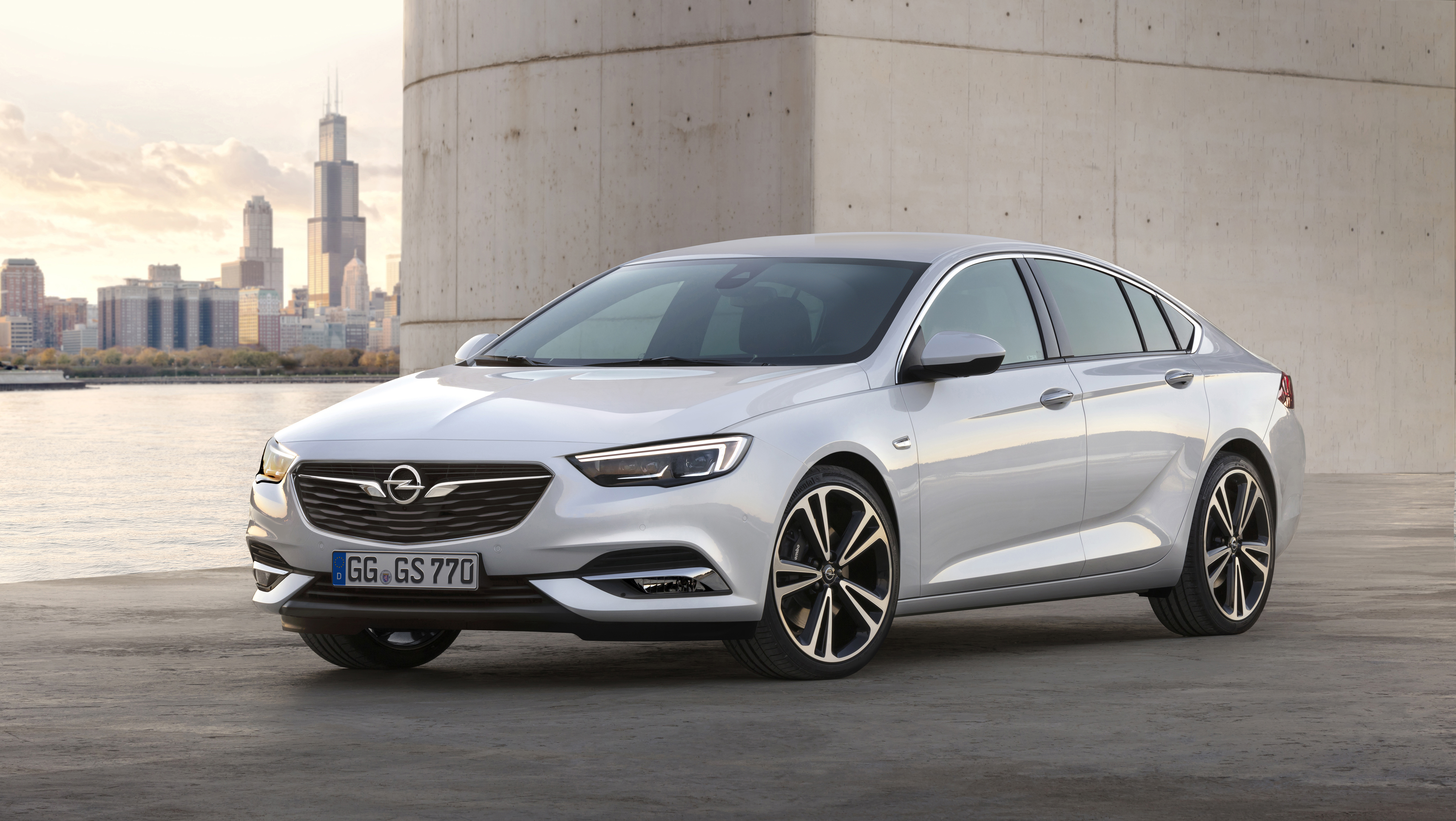 A white Opel Insignia Grand Sport sedan.