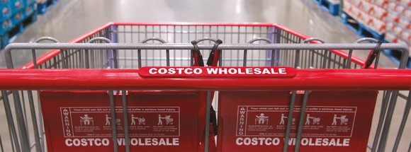 A Costco shopping cart moving down the aisle.