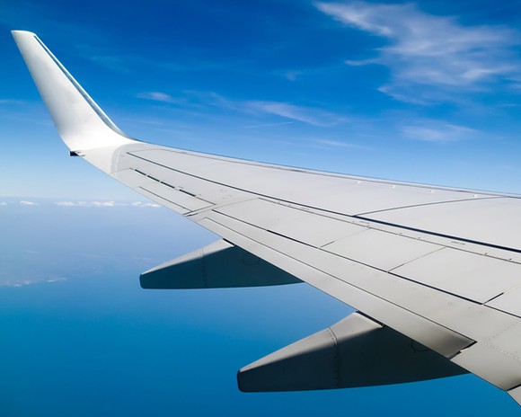 View of a wing of an airplane in the sky.