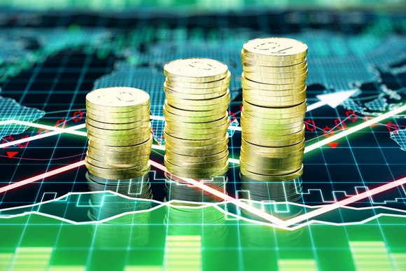 Stacks of gold coins on a financial chart.