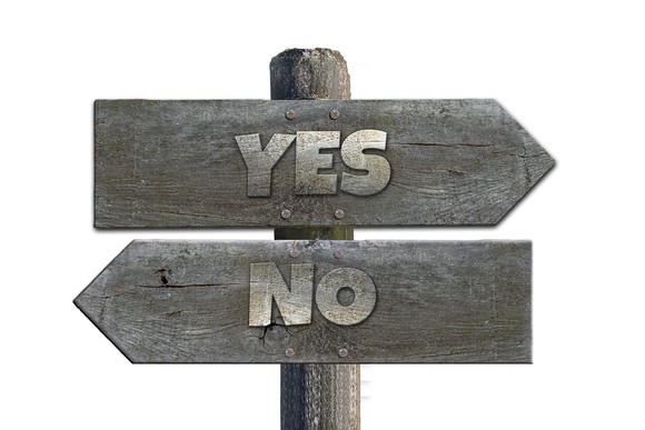Signs at intersection, one says yes, one says no