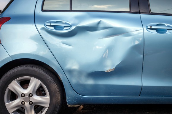 Picture of the dented side of a car.