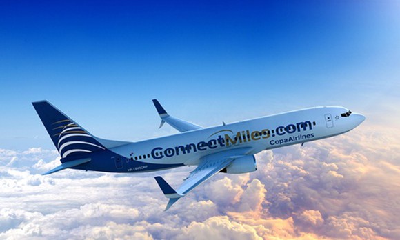A Copa Airlines plane, flying above the clouds