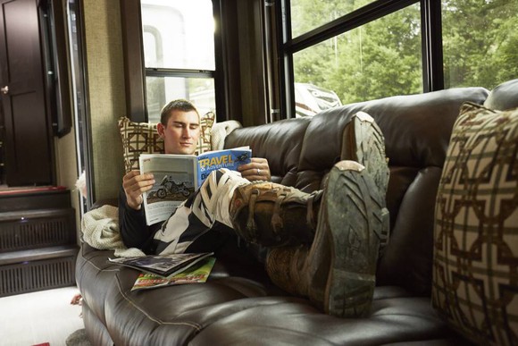 RV owner sitting on a couch in his RV.