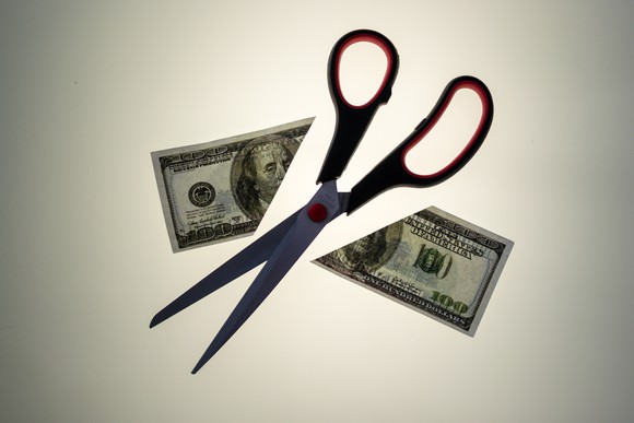 scissors cutting bill in half