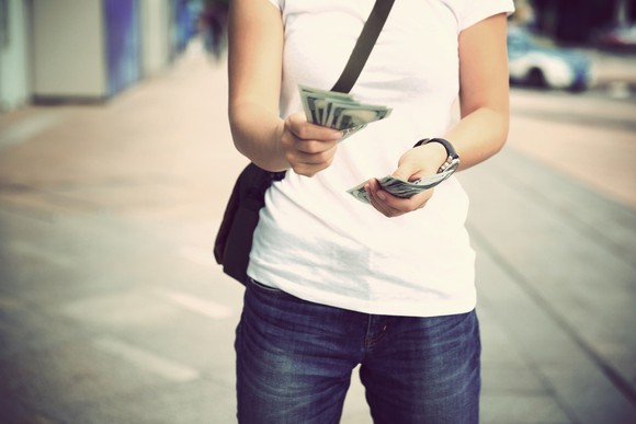 Lady handing out cash