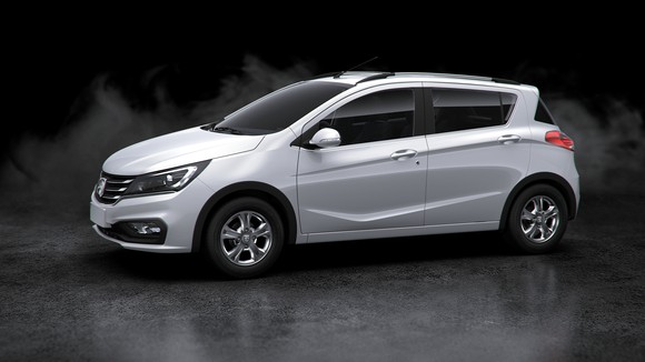 A white Baojun 310 hatchback against a black background.
