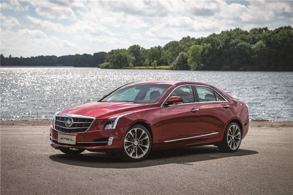 A red Cadillac ATS-L sedan next to a lake.