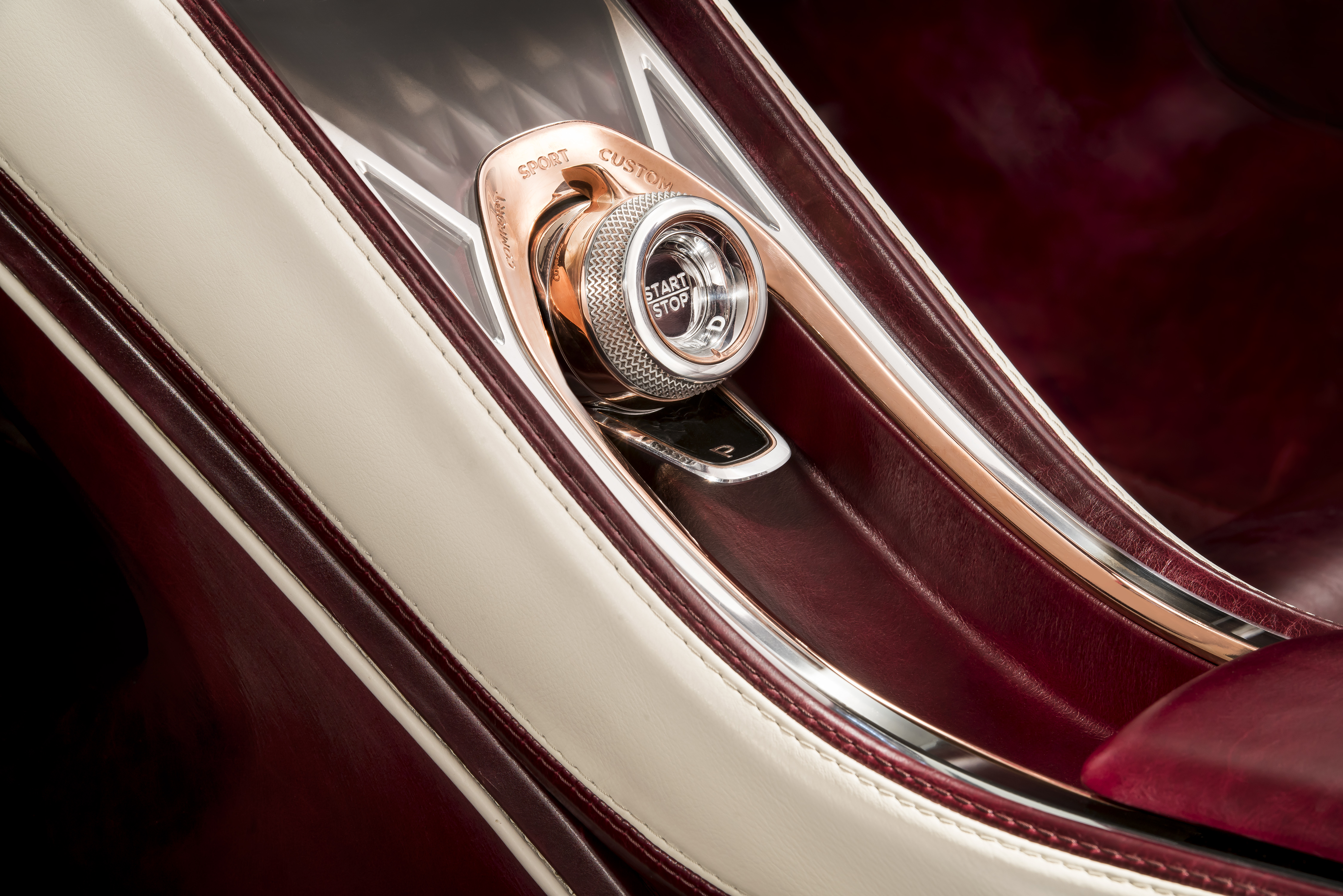 A close-up of the glass "Start" button in the Bentley EXP 12 Speed 6e Concept.